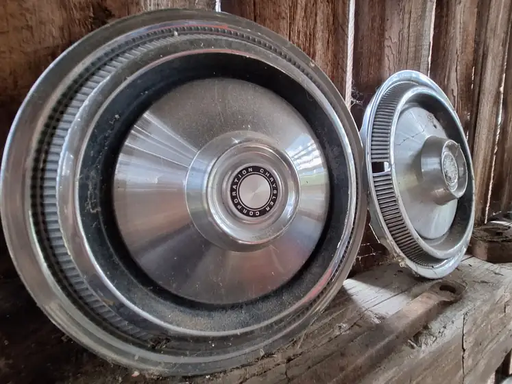 Vintage hubcaps on a barn shelf