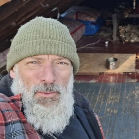 Tim Rouble, owner of Ravens Ridge Junk Removal, in a green knit toque and a red plaid jacket